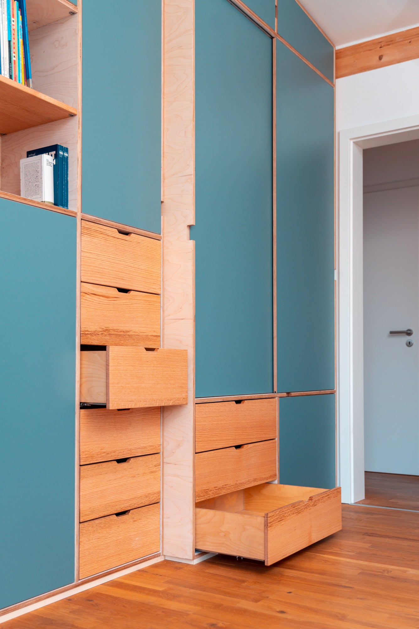 Einbauschrank unter der Treppe mit maßgefertigten blauen Türen und Holz-Schubladen, Schrank nach Maß als Kleiderschrank und.