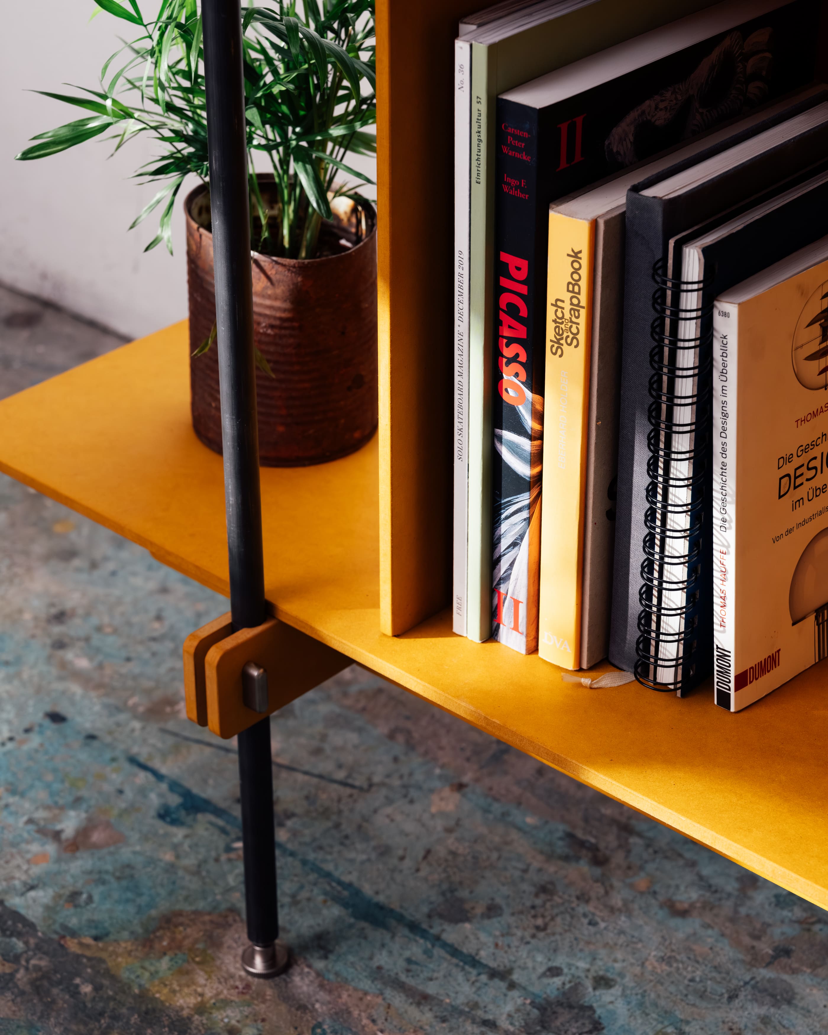 Regalsystem Holz mit schwarzem Stahlrahmen, offenes Design, rechteckige gelbe Holzplatte.