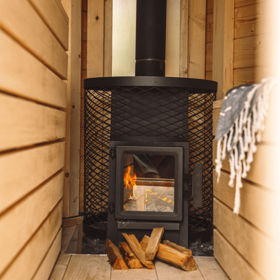 Detailaufnahme vom gemütlichen Innenraum einer mobilen Sauna. Das Bild zeigt das hochwertige Holz und den Holzofen für ein entspanntes Saunaerlebnis, ideal für den Schwarzwald oder für alle, die eine Sauna kaufen möchten.