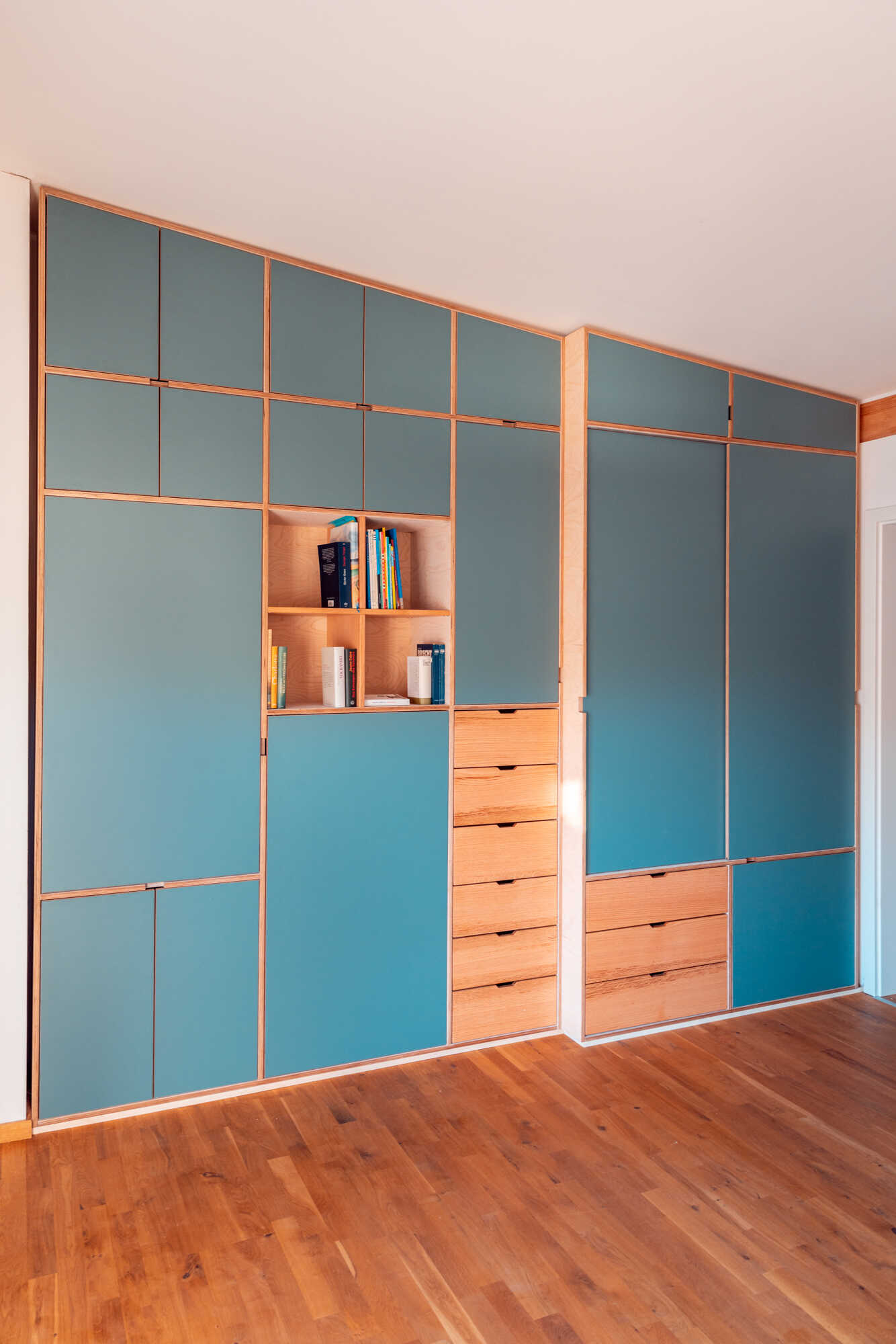 Einbauschrank unter der Treppe in Blau mit Holzrahmen, Schrank nach Maß mit integriertem Bücherschrank und Schubladen,.